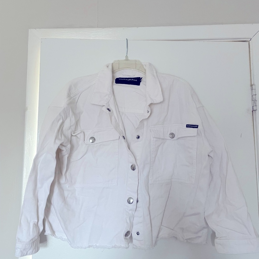 Oversized Calvin Klein white denim jacket with frayed edge.  Slightly used.